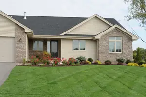 Residential lawn with a mow-stripe pattern and a colourful planting bed